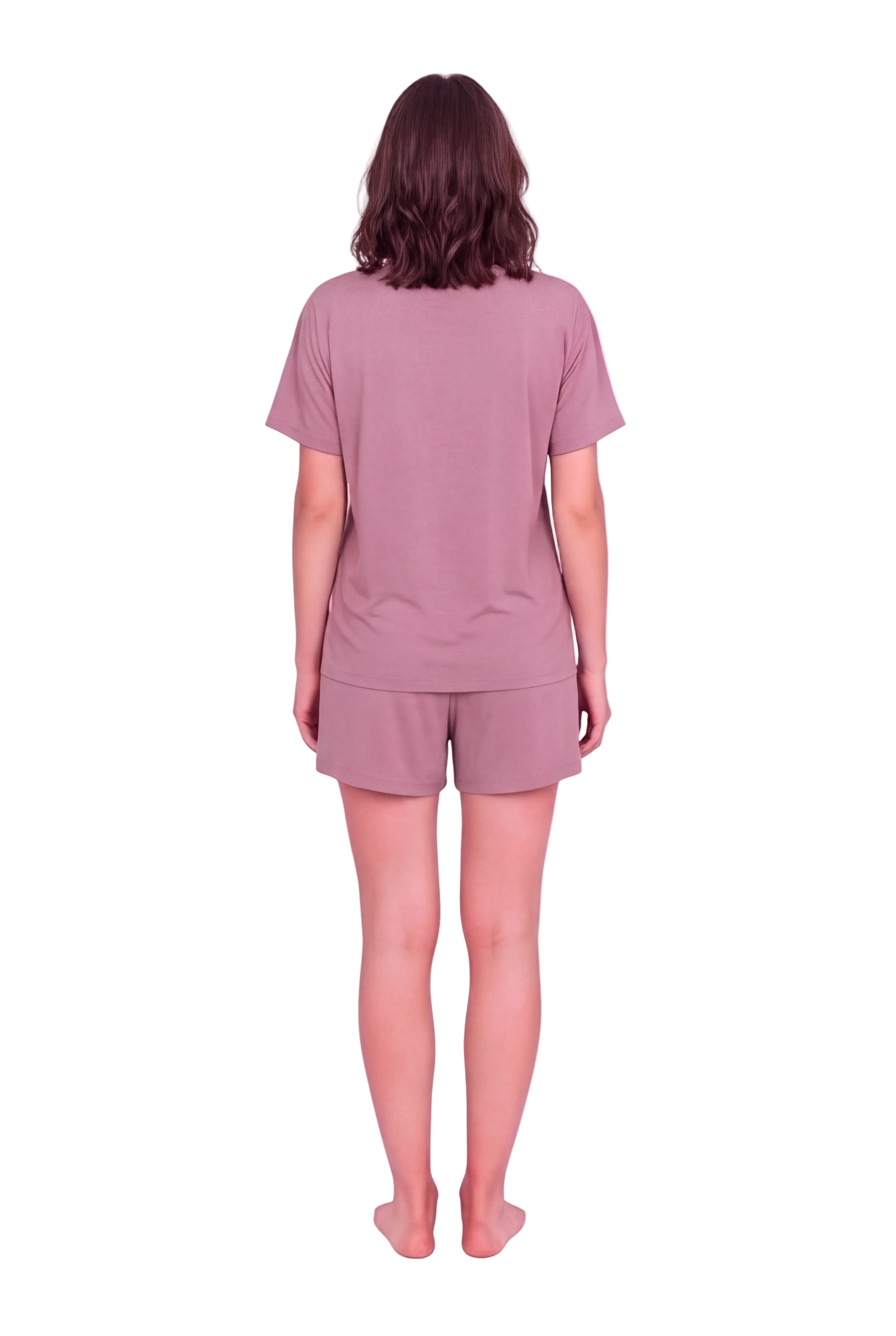 A woman standing with her back to the camera wearing a matching mauve short-sleeve t-shirt and shorts set against a solid pale pink studio background.
